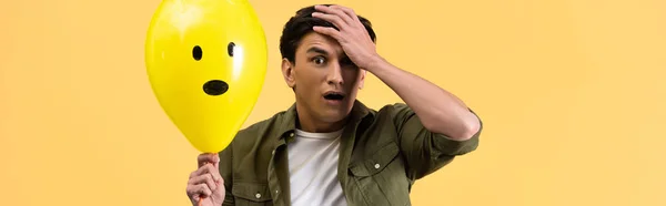 Panoramic Shot Worried Man Holding Shocked Balloon Isolated Yellow — Stockfoto