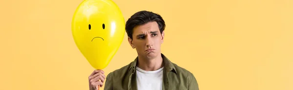 Panoramic Shot Brunette Young Man Holding Upset Balloon Isolated Yellow — Stock Photo, Image