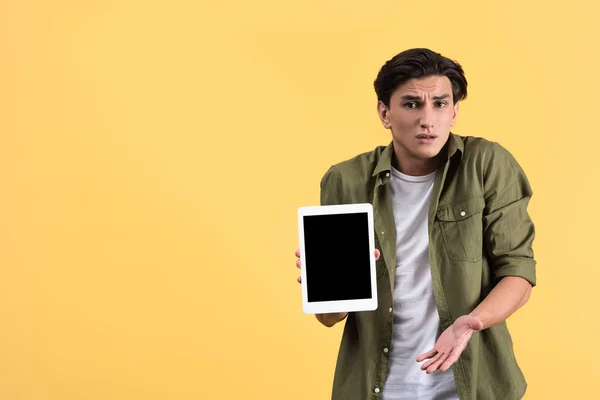 Confused Man Showing Digital Tablet Blank Screen Isolated Yellow — Stock Photo, Image