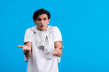 frustrated man with shrug gesture, isolated on blue