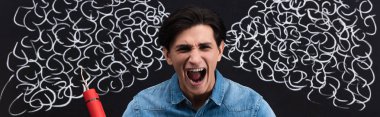 panoramic shot of aggressive young man yelling and holding dynamite sticks, with steam drawing on blackboard clipart
