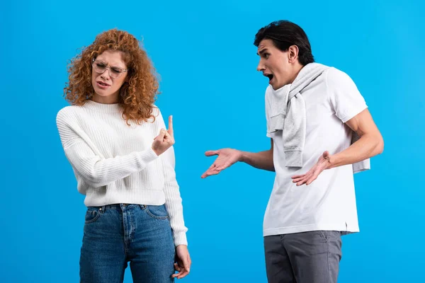 Irritated Girlfriend Showing Middle Finger Angry Boyfriend Isolated Blue — Stock Photo, Image