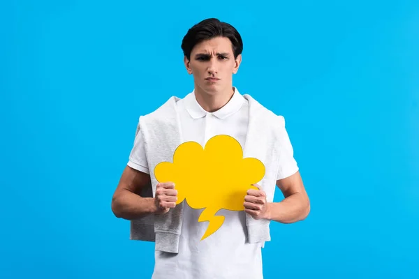 Irritated Man Holding Yellow Cloud Speech Bubble Isolated Blue — Stock Photo, Image