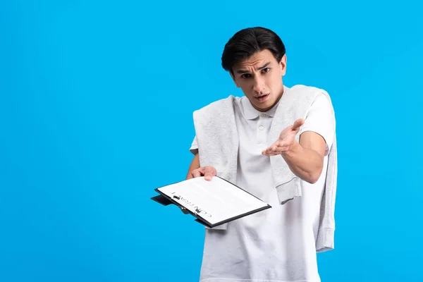 Irritated Man Holding Clipboard Contract Isolated Blue — 스톡 사진
