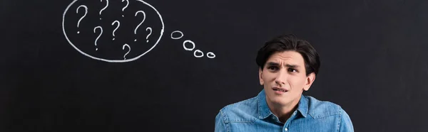 Panoramic Shot Confused Young Man Question Marks Thought Bubble Blackboard — Stock Photo, Image