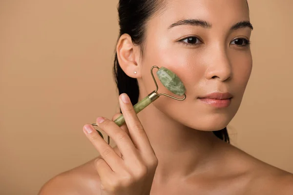 Beautiful Naked Asian Girl Massaging Face Jade Roller Isolated Beige — Stock Photo, Image