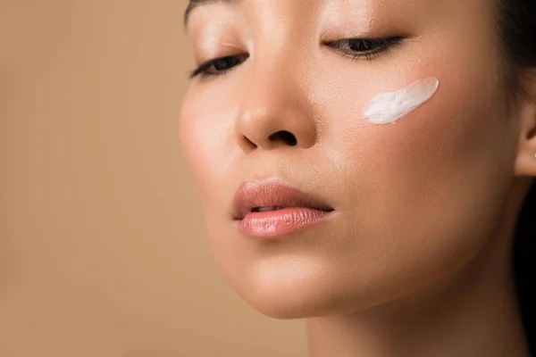 Beautiful Asian Girl Facial Cream Cheek Isolated Beige — Stock Photo, Image