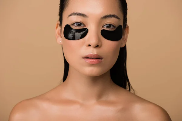美しい裸のアジアの少女黒のハイドロゲルの目のパッチがベージュで隔離された — ストック写真