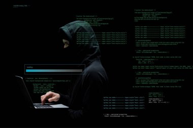 anonymous hacker in hood and mask using laptop near data on black  clipart