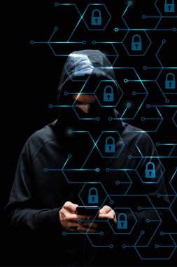 hacker in hood using smartphone near padlocks on black, cyber security concept  clipart