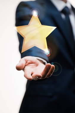 cropped view of businessman in suit with outstretched hand near star on white, quality concept  clipart