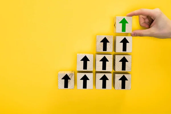 Top View Man Holding Wooden Cube Directional Arrow Isolated Yellow — Stock Photo, Image