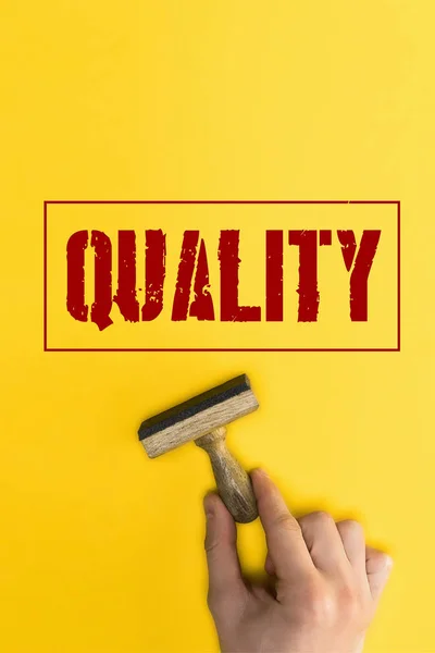Top View Man Holding Stamp Quality Lettering Yellow — Stock Photo, Image