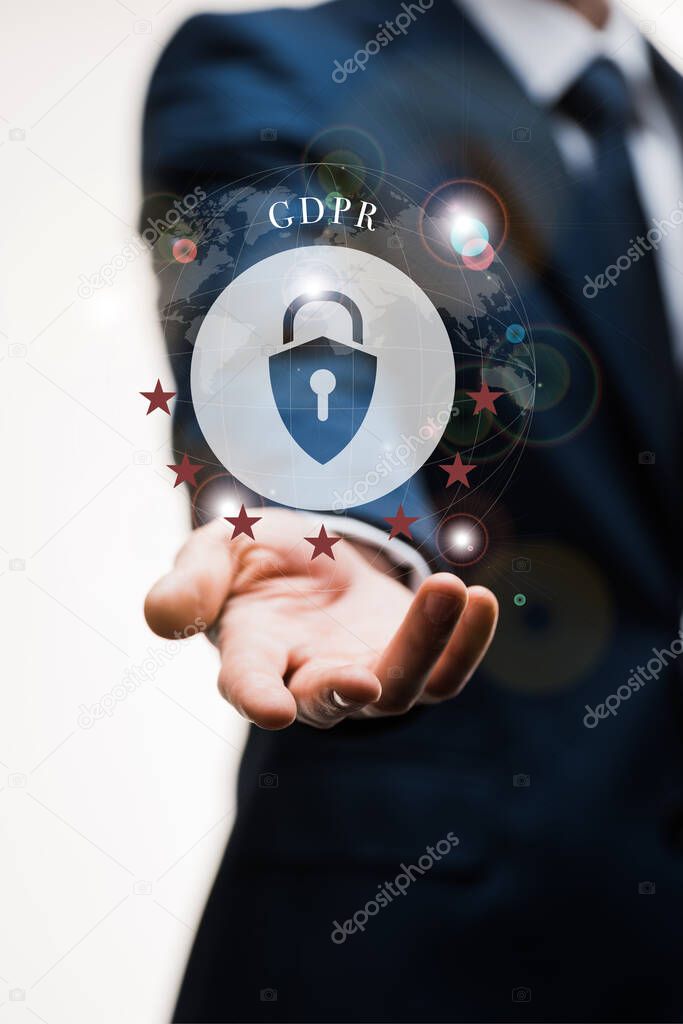 cropped view of businessman in suit with outstretched hand near gdpr lettering on white 