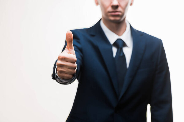 selective focus of businessman in suit showing thumb up isolated on white 