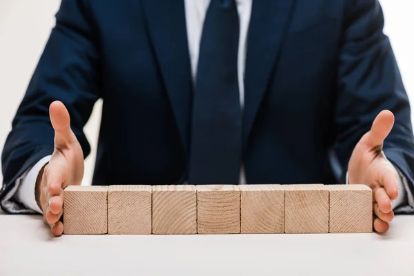 Cropped View Businessman Putting Hands Surface Wooden Cubes Isolated White — Stock Photo, Image