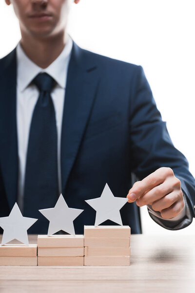 cropped view of businessman touching star isolated on white, quality concept 