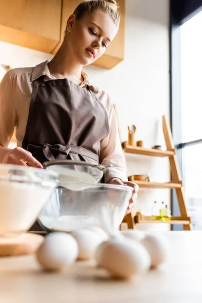 Selective Focus Woman Sieving Flour Glass Bowl Raw Eggs Table — Stock Photo, Image