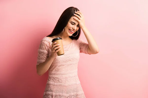 Happy Girl Touching Head While Holding Coffee Pink Background — Stock Photo, Image