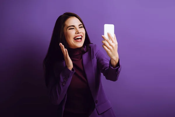 Happy Girl Waving Hand While Having Video Call Purple Background — Stock Photo, Image