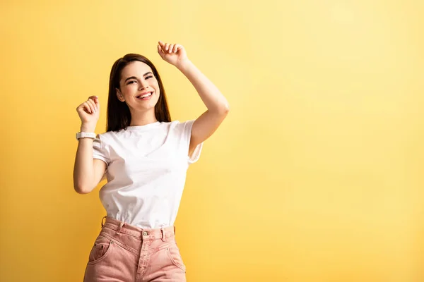 Happy Girl Dancing Raised Hands While Smiling Camera Isolated Yellow — Stock Photo, Image