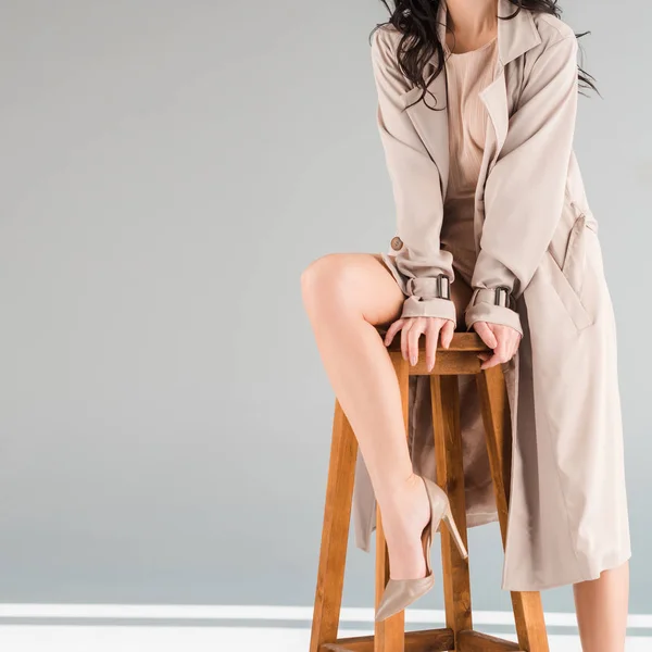 Cropped View Woman Coat Sitting Stool Grey Background — Stock Photo, Image