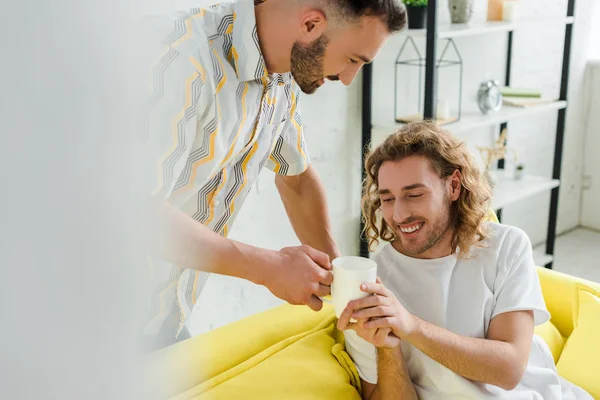 Вибірковий Фокус Щасливих Гомосексуальних Чоловіків Тримає Чашку Чаєм Вдома — стокове фото