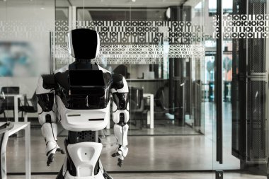 humanoid robot standing in conference hall of modern office clipart