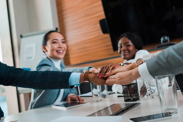 Selective Focus Young Multicultural Businesspeople Holding Joined Hands While Sitting — Stock Photo, Image