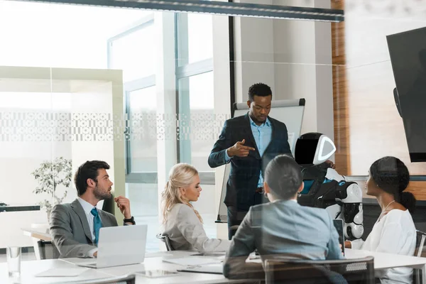 Handsome African American Businessman Showing Robot Multicultural Colleagues Office — Stock Photo, Image