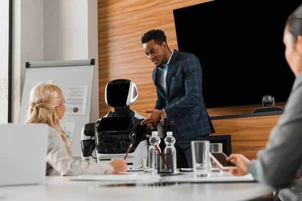 Handsome African American Businessman Pointing Finger Robot Colleagues Conference Hall — Stock Photo, Image
