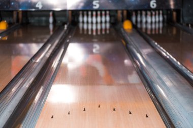 selective focus of bowling alley and skittles in bowling club clipart
