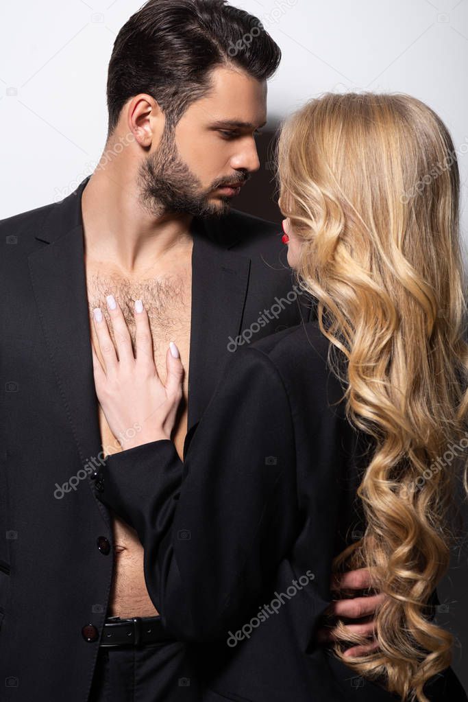 handsome bearded man hugging beautiful woman on white 