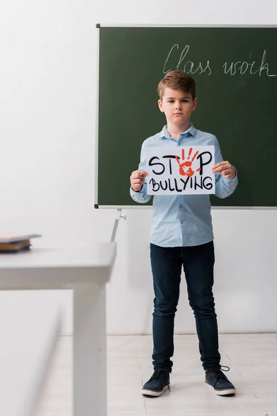 Selective Focus Schoolchild Holding Placard Stop Bullying Lettering Classroom — Stock Photo, Image