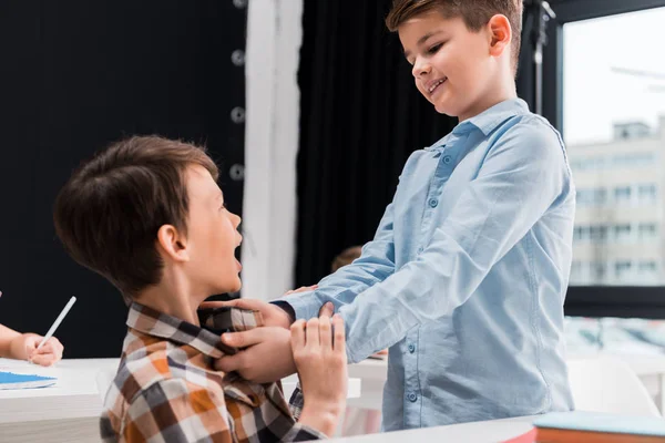 Selective Focus Cruel Schoolkid Smiling While Bullying Classmate — Stock Photo, Image