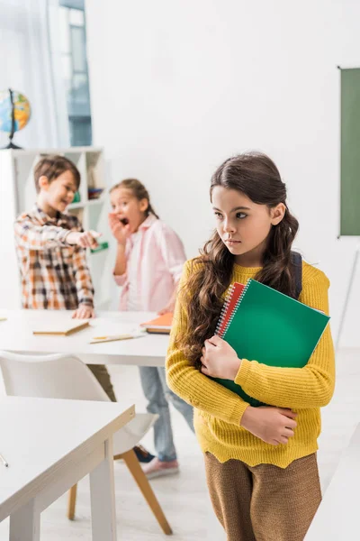 Enfoque Selectivo Colegiala Acosada Sosteniendo Cuadernos Cerca Compañeros Clase Crueles — Foto de Stock