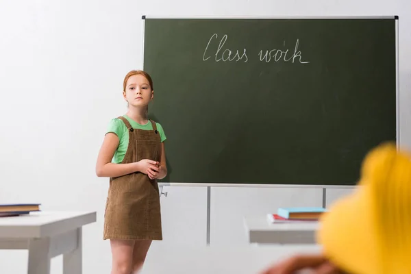 Selective Focus Upset Schoolgirl Standing Chalkboard Class Work Lettering — Stock Photo, Image