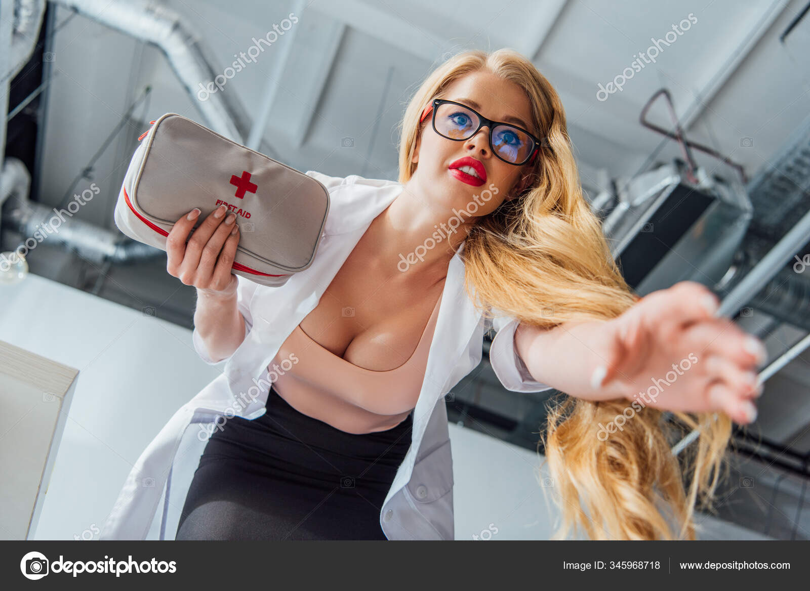 Low Angle View Sexy Nurse Big Breast Holding First Aid Stock Photo by  ©VitalikRadko 345968718