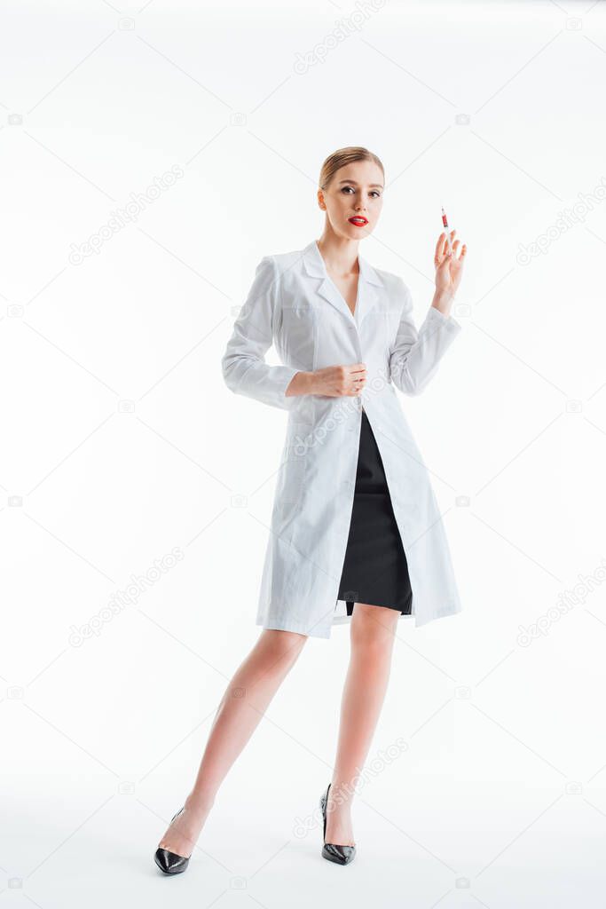 sexy nurse in white coat holding syringe on white 