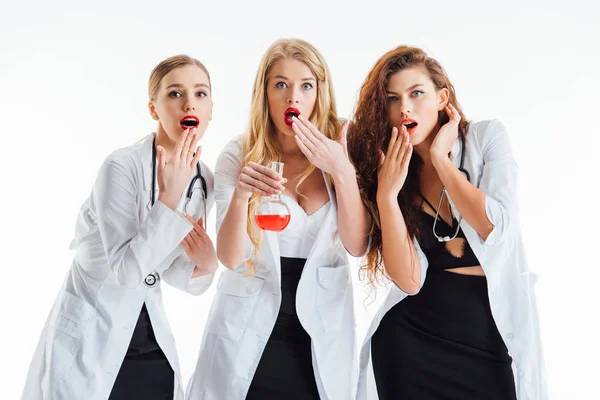 Surprised Sexy Nurses Looking Camera Glass Flask Red Liquid Isolated — Stock Photo, Image
