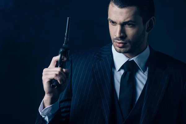Pensive Gangster Raising Gun Dark Blue Background — 스톡 사진