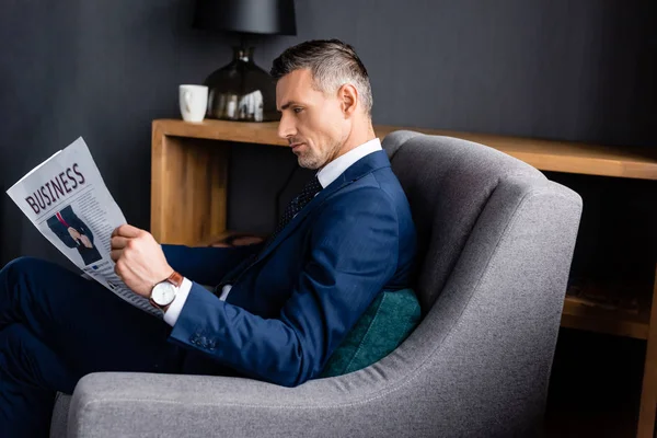 Zijaanzicht Van Zakenman Pak Lezen Krant Met Zakelijke Belettering Zitten — Stockfoto