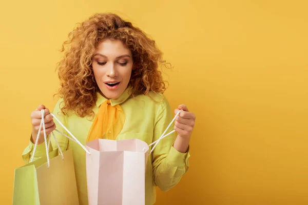 Surprised Redhead Girl Looking Shopping Bag Yellow — Stock Photo, Image