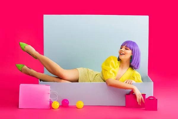 Cheerful Girl Purple Wig Doll Lying Blue Box Shopping Bags — Stock Photo, Image