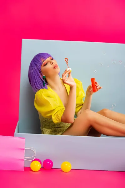 Beautiful Girl Purple Wig Doll Blowing Soap Bubbles While Sitting — Stock Photo, Image