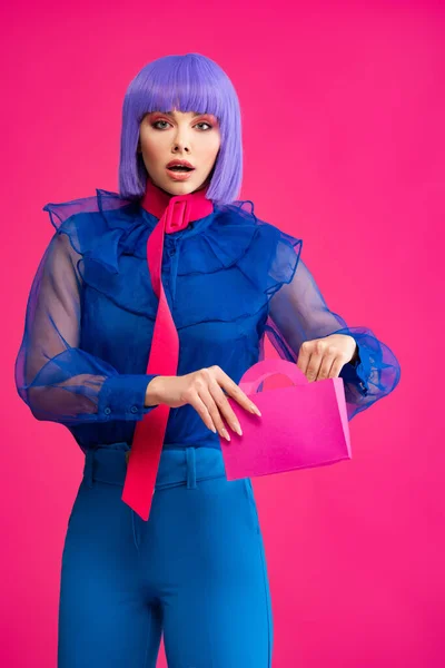 Stylish Shocked Girl Purple Wig Holding Little Shopping Bag Isolated — Stock Photo, Image