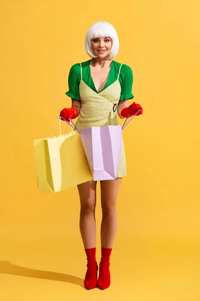 Sonriente Chica Arte Pop Peluca Blanca Sosteniendo Bolsas Compras Amarillo — Foto de Stock