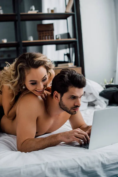 Smiling Woman Lying Handsome Boyfriend Using Laptop Bed — Stock Photo, Image