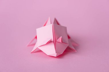 selective focus of small origami rhinoceros on pink with copy space  clipart