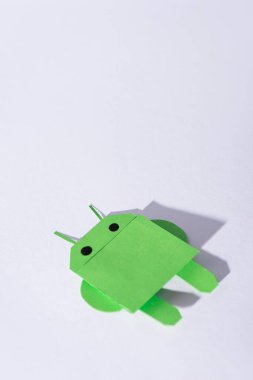 KYIV, UKRAINE - FEBRUARY 13, 2020: green origami android robot on white  clipart
